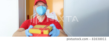 Male courier in protective mask and gloves delivers gift box 81638011