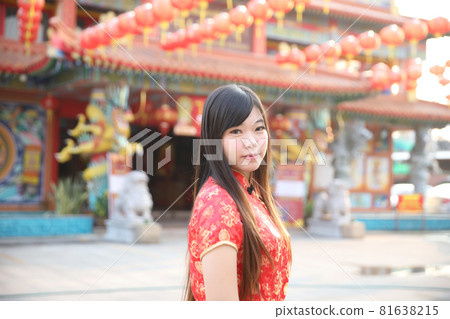 beauty woman wear red cheongsam looking and smile in chinese new year 81638215