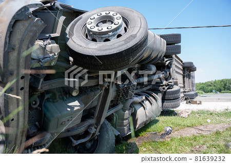 The truck is lying on its side in a car accident on the highway The truck is lying on its side in a car accident on the highway 81639232
