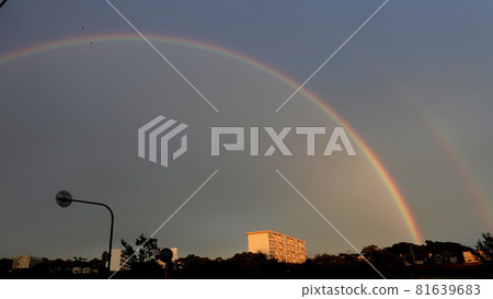 A big rainbow in the evening at the end of summer A big rainbow in the evening at the end of summer 81639683