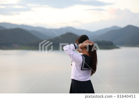 Asian school girl looking mountain with river in sunrise 81640451