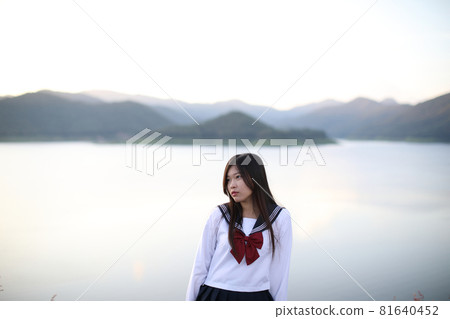 Asian school girl looking mountain with river in sunrise Asian school girl looking mountain with river in sunrise 81640452