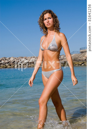 European young blonde girl enjoying a day at the beach near the sea European young blonde girl enjoying a day at the beach near the sea 81641256