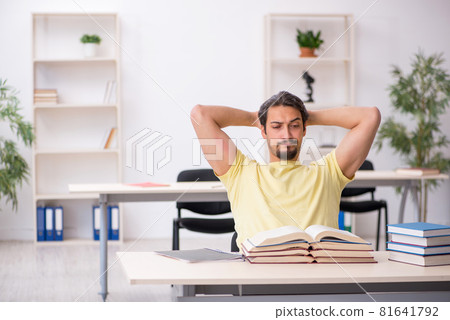 Young male student preparing for exams in the classroom 81641792