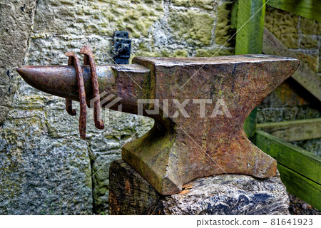 Beautiful vintage display with anvil and aged horseshoes 81641923