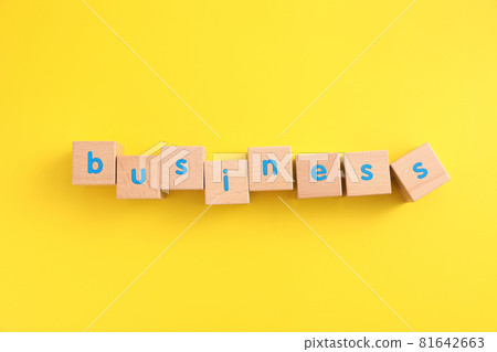 Business concept wooden blocks with word business strategy icons on yellow background Business concept wooden blocks with word business strategy icons on yellow background 81642663