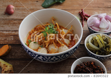 Local northern Thai food Egg noodle curry with meatballs on wood background Local northern Thai food Egg noodle curry with meatballs on wood background 81643322