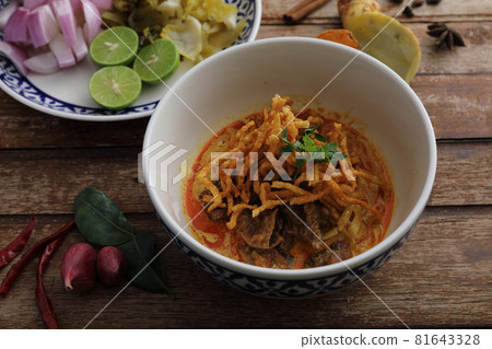 Local northern Thai food Egg noodle curry with beef on wood background 81643328