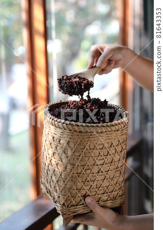 Boiled riceberry rice on wood basket with spoon in close up 81643353