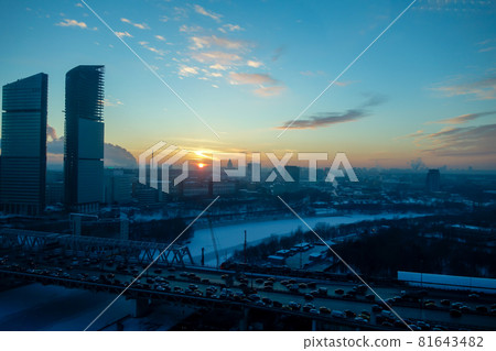 Cold winter Moscow skyline, setting sun and frozen river 81643482