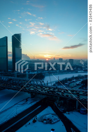 Cold winter Moscow skyline, setting sun and frozen river 81643486