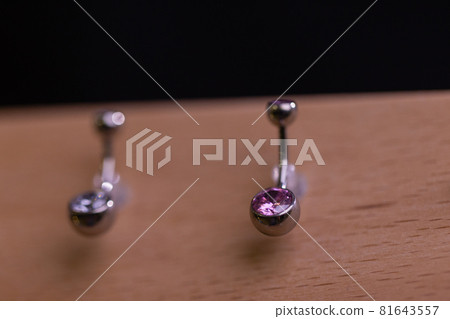 ear jewelry, piercing in hand with a disposable glove. 81643557