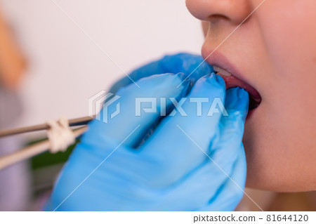 Close up portrait of young Caucasian woman sticking out pierced tongue. 81644120