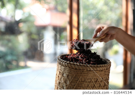 Boiled riceberry rice on wood basket with spoon in close up 81644534