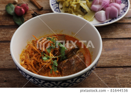 Local northern Thai food Egg noodle curry with pork ribs on wood background 81644536