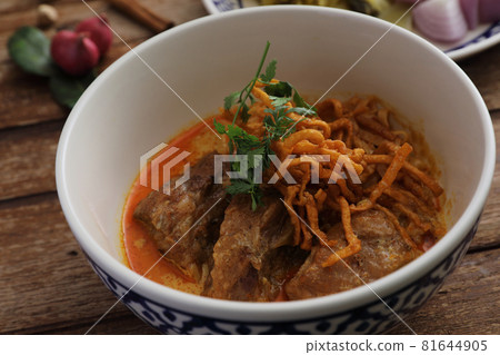 Local northern Thai food Egg noodle curry with pork ribs on wood background 81644905