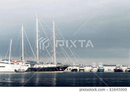 Large sailing yacht among the smaller yachts at the marina Large sailing yacht among the smaller yachts at the marina 81645000