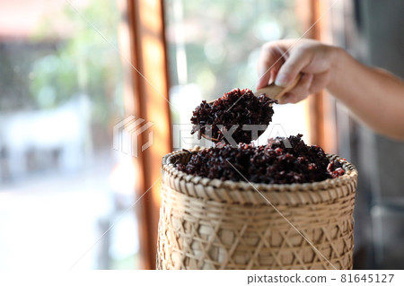 Boiled riceberry rice on wood basket with spoon in close up Boiled riceberry rice on wood basket with spoon in close up 81645127