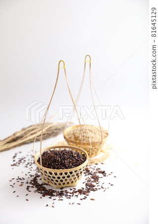 Organic raw brown rice and riceberry rice on wood basket in close up Organic raw brown rice and riceberry rice on wood basket in close up 81645129