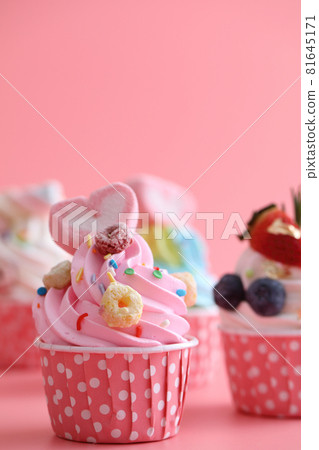 Colorful cupcakes isolated in pink background Colorful cupcakes isolated in pink background 81645171
