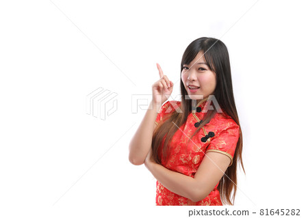beauty woman wear red cheongsam point and smile in chinese new year 81645282