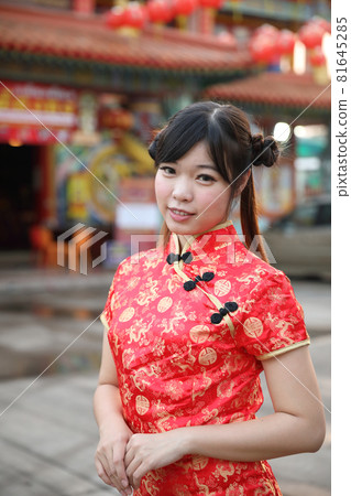 beauty woman wear red cheongsam looking and smile in chinese new year beauty woman wear red cheongsam looking and smile in chinese new year 81645285