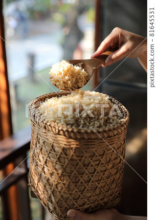 Organic boiled brown rice on Wicker basket in close up 81645531