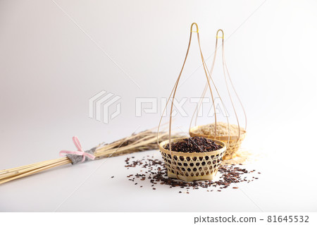 Organic raw brown rice and riceberry rice on wood basket in close up Organic raw brown rice and riceberry rice on wood basket in close up 81645532