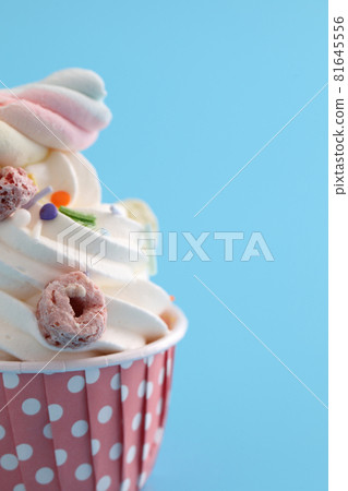 Colorful cupcake isolated in blue background Colorful cupcake isolated in blue background 81645556