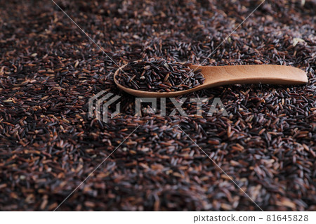 Organic raw riceberry rice on spoon in close up Organic raw riceberry rice on spoon in close up 81645828
