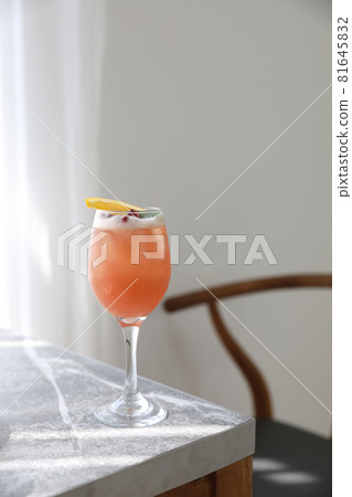 Pink Cocktail glass with ice at gray table Pink Cocktail glass with ice at gray table 81645832