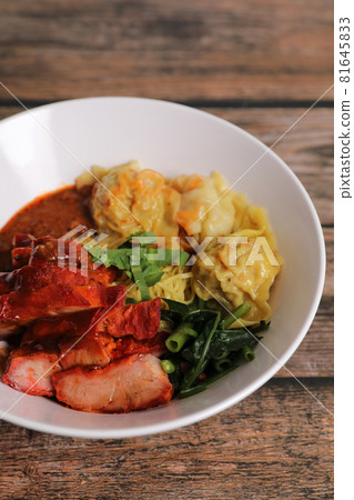 Shrimp dumpling with roasted pork with local thai tom yum spicy sauce on wood background 81645833
