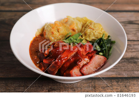 Shrimp dumpling with roasted pork with local thai tom yum spicy sauce on wood background 81646193