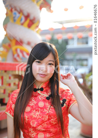 beauty woman wear red cheongsam looking and smile in chinese new year 81646676