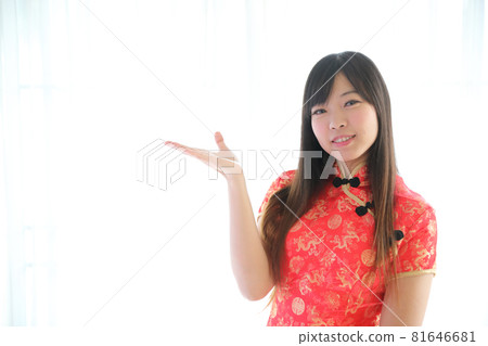 beauty woman wear red cheongsam looking and smile in chinese new year 81646681