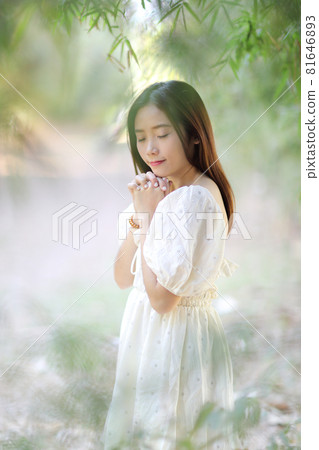 Beautiful young woman with white dress on garden background Beautiful young woman with white dress on garden background 81646893