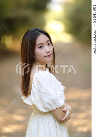 Beautiful young woman with white dress on garden background Beautiful young woman with white dress on garden background 81646901