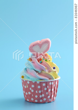 Colorful cupcake isolated in blue background Colorful cupcake isolated in blue background 81646987