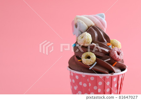 Chocolate cupcake isolated in pink background Chocolate cupcake isolated in pink background 81647027