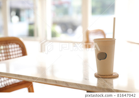 Iced coffee with paper glass in coffee shop background Iced coffee with paper glass in coffee shop background 81647042