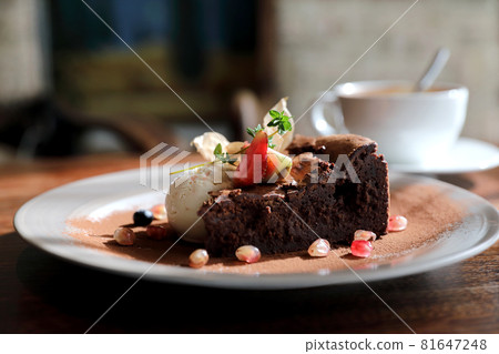 Chocolate cake with ice cream and coffee dessert on wood table Chocolate cake with ice cream and coffee dessert on wood table 81647248