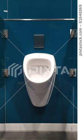 White urinal for men's bathroom, on blue tiles, Munich airport, Germany 81648869
