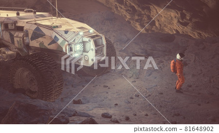 An astronaut is working at a computer next to his rover on an alien, unexplored desert planet. 3D Rendering An astronaut is working at a computer next to his rover on an alien, unexplored desert planet. 3D Rendering 81648902