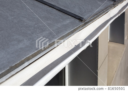 roof gutter made of stainless sheets rainwater drainage pipe close-up, nobody. roof gutter made of stainless sheets rainwater drainage pipe close-up, nobody. 81650501