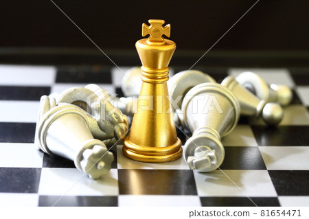 gold King chess surrounded by a number of fallen silver chess pieces , business strategy concept 81654471