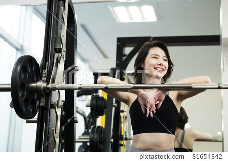 Women training sports gym barbell smile Women training sports gym barbell smile 81654842