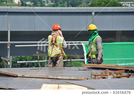 SEREMBAN, MALAYSIA -JULY 01, 2016: Construction workers working at the construction site at Seremban, Malaysia during daytime. They are wearing proper safety gear to ensure they are safe working.   81656876