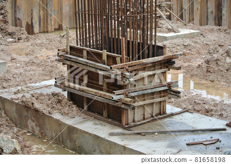 KUALA LUMPUR, MALAYSIA -JUNE 18, 2016: Column timber form work and reinforcement bar at the construction site. Installed by construction workers. The structure supported by temporary wood support. 81658198