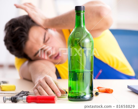 Drunk engineer working in the workshop Drunk engineer working in the workshop 81658829