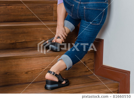 Woman loses control and cannot walk on stairs, she stops and hold her legs for support and rest with feel tingling. Concept of Guillain barre syndrome and numb legs disease or vaccine side effect Woman loses control and cannot walk on stairs, she stops and hold her legs for support and rest with feel tingling. Concept of Guillain barre syndrome and numb legs disease or vaccine side effect 81660550